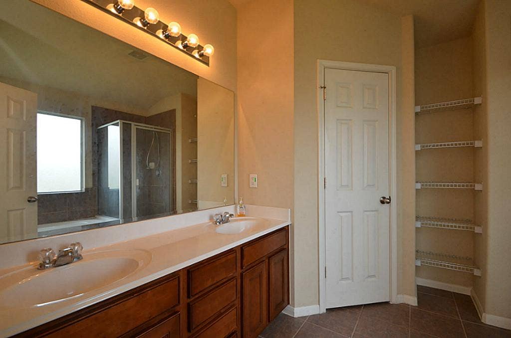 2502 Quiet Sage Lane, Katy, TX 77494 Elegant primary bath with dual sinks and a spacious mirror.