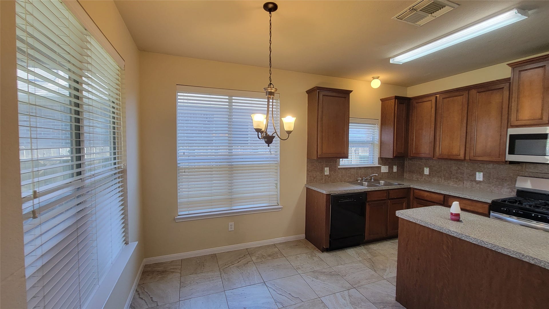 2502 Quiet Sage Lane, Katy, TX 77494 This kitchen features elegant wood-finished cabinetry, adding warmth and style.