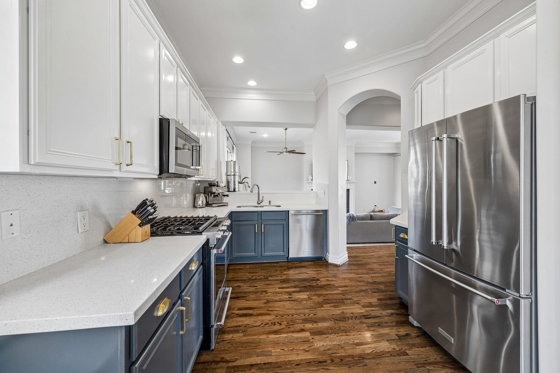 Large 2nd floor  kitchen updated in 2021 with stainless steel appliances, elegant quartz countertops. painted cabinetry, and warm hardwood floors, seamlessly connecting to the living area.