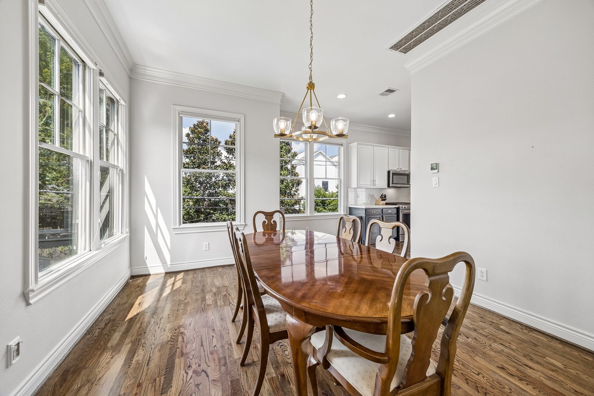 The dining room creates a cozy space for dinner parties or could serve as an additional office or children's play area while seamlessly connected to the kitchen. The designer light fixture (2025) polishes it off.