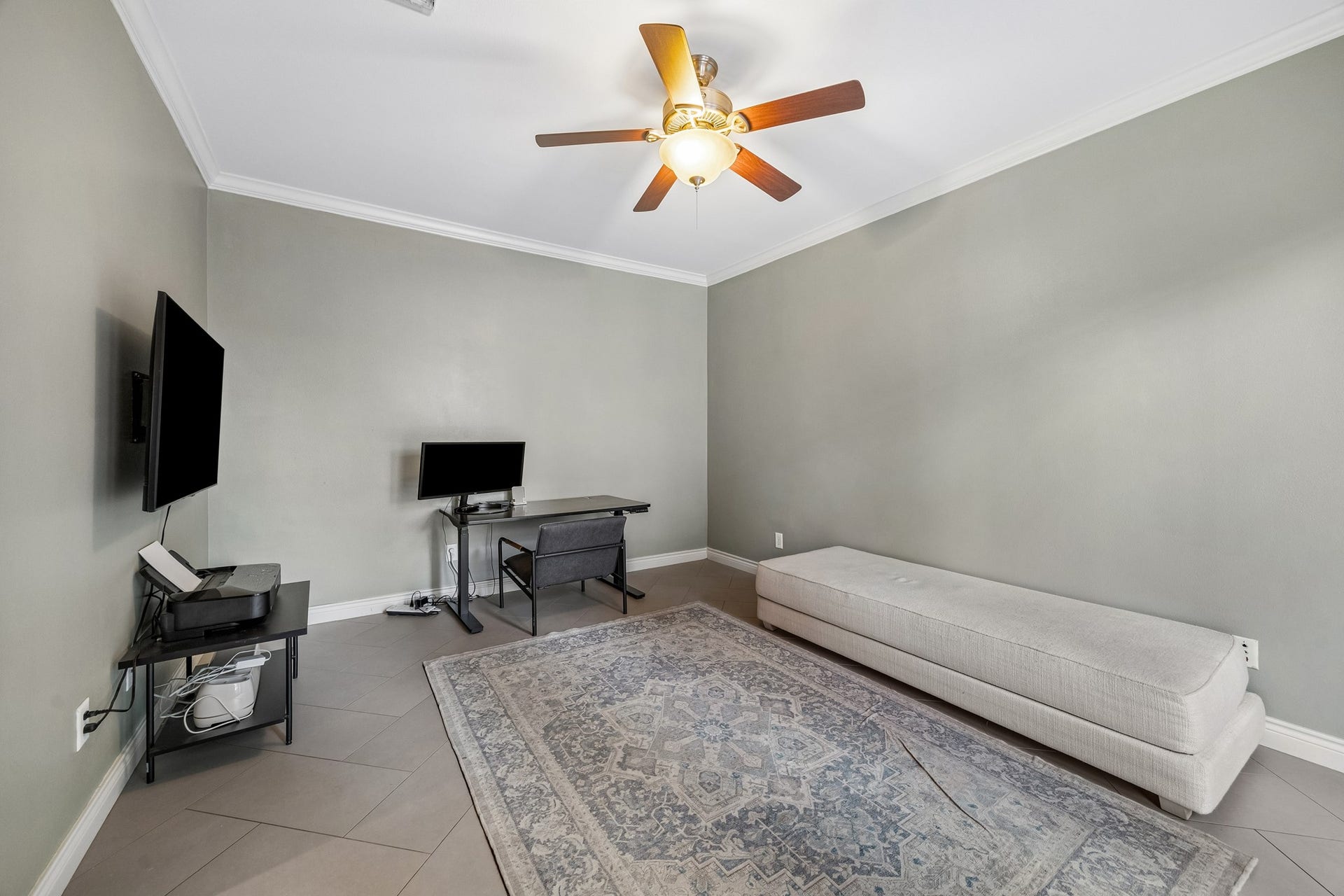Secondary spacious bedroom conveniently located  on the 1st floor has crown molding, walk in closet and nearby hallway bathroom. The herringbone patterned tile continues throughout the first floor.