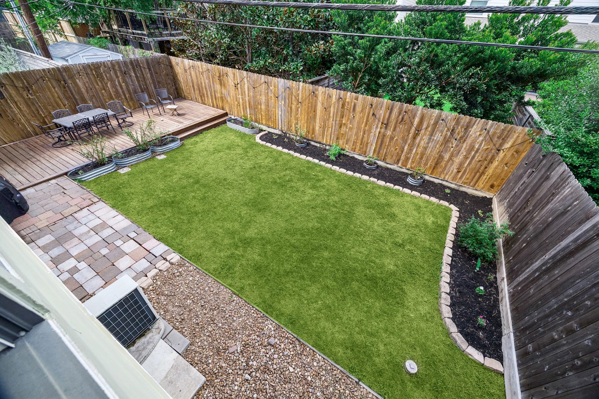 This aerial view of the charming backyard oasis shows how versatile and private the space is