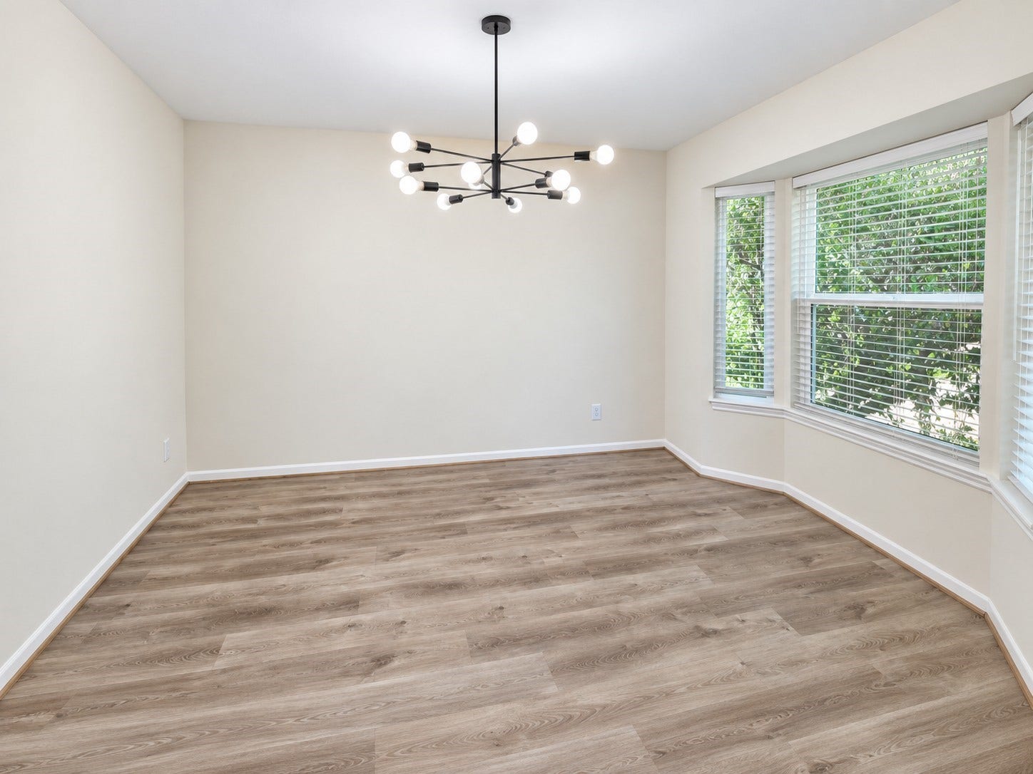 5527 Wigton Drive, Houston, TX 77096 Light-filled dining room with bay windows creates an inviting setting for meals and gatherings.