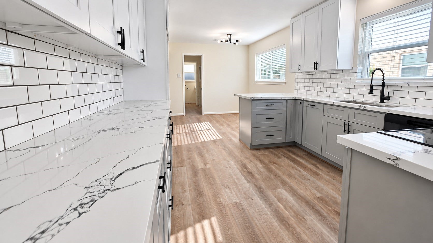 5527 Wigton Drive, Houston, TX 77096 Sleek kitchen view highlights the subway-tile backsplash, veined countertops, and abundant cabinetry.
