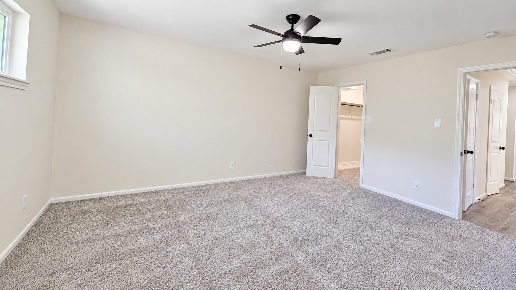 5527 Wigton Drive, Houston, TX 77096 Alternate view of the spacious primary bedroom highlights excellent wall space and easy access to the adjoining areas.