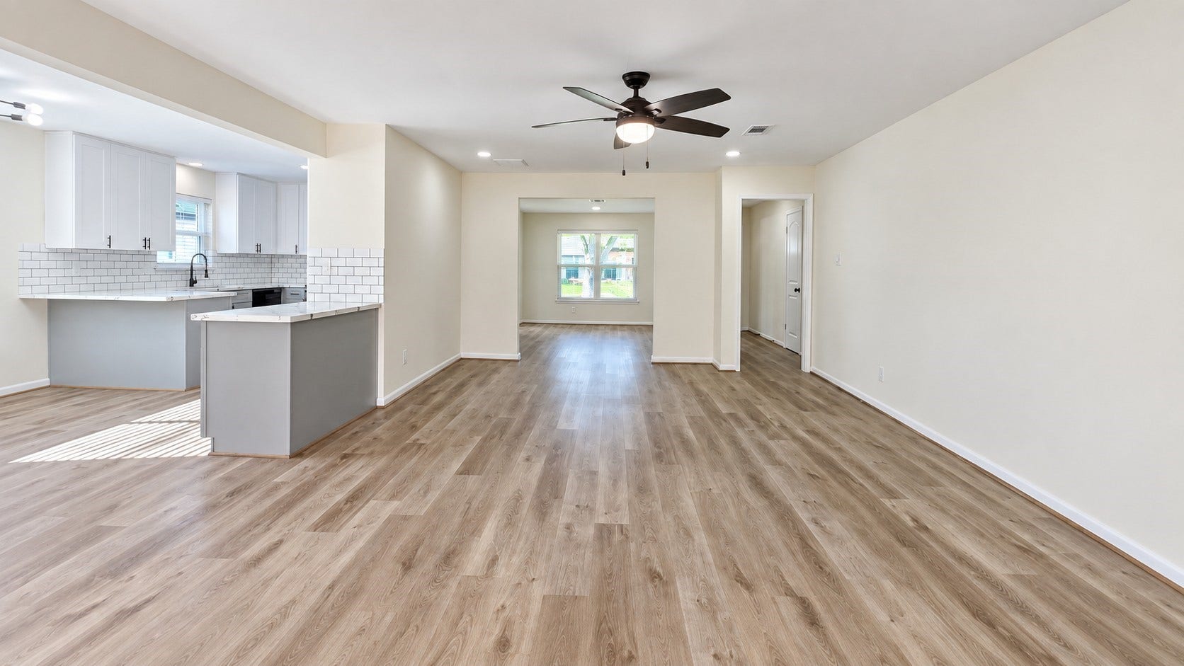 5527 Wigton Drive, Houston, TX 77096 Another view of the open living space highlighting the generous footprint and connection to the kitchen.