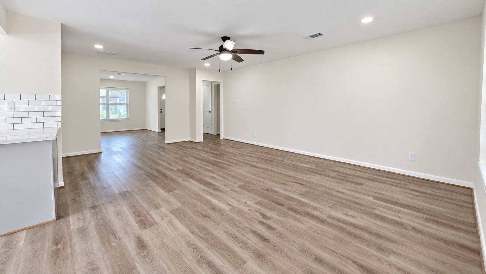 5527 Wigton Drive, Houston, TX 77096 Wide-angle view showcases the size of the main living room and its versatile furniture possibilities.