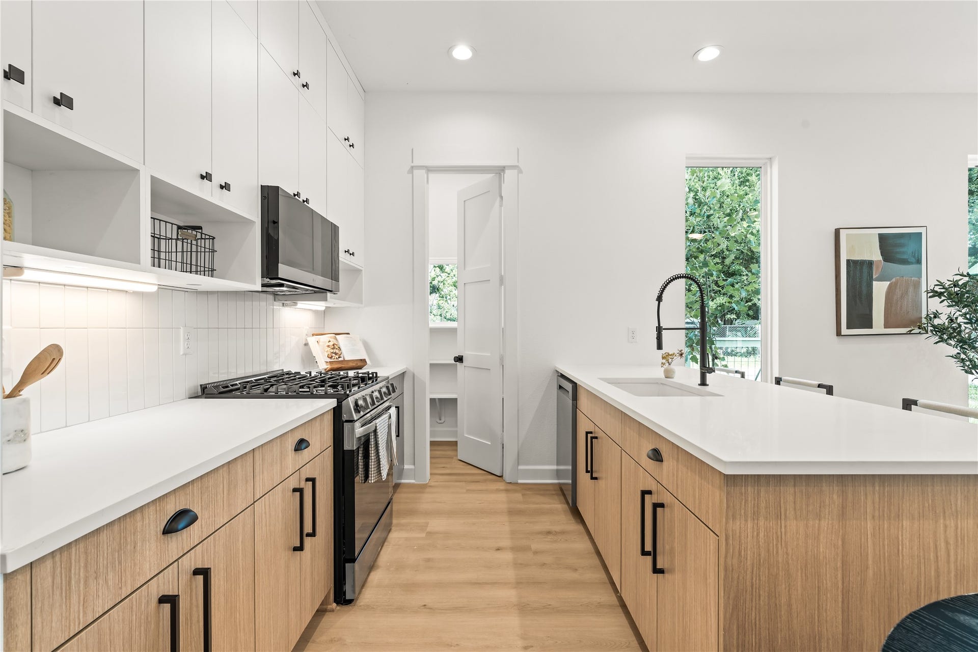 7432-7444 Tremper Street, Houston, TX 77020 White upper cabinets, warm wood lowers a kitchen built with contrast in mind, equally with storage maximization.