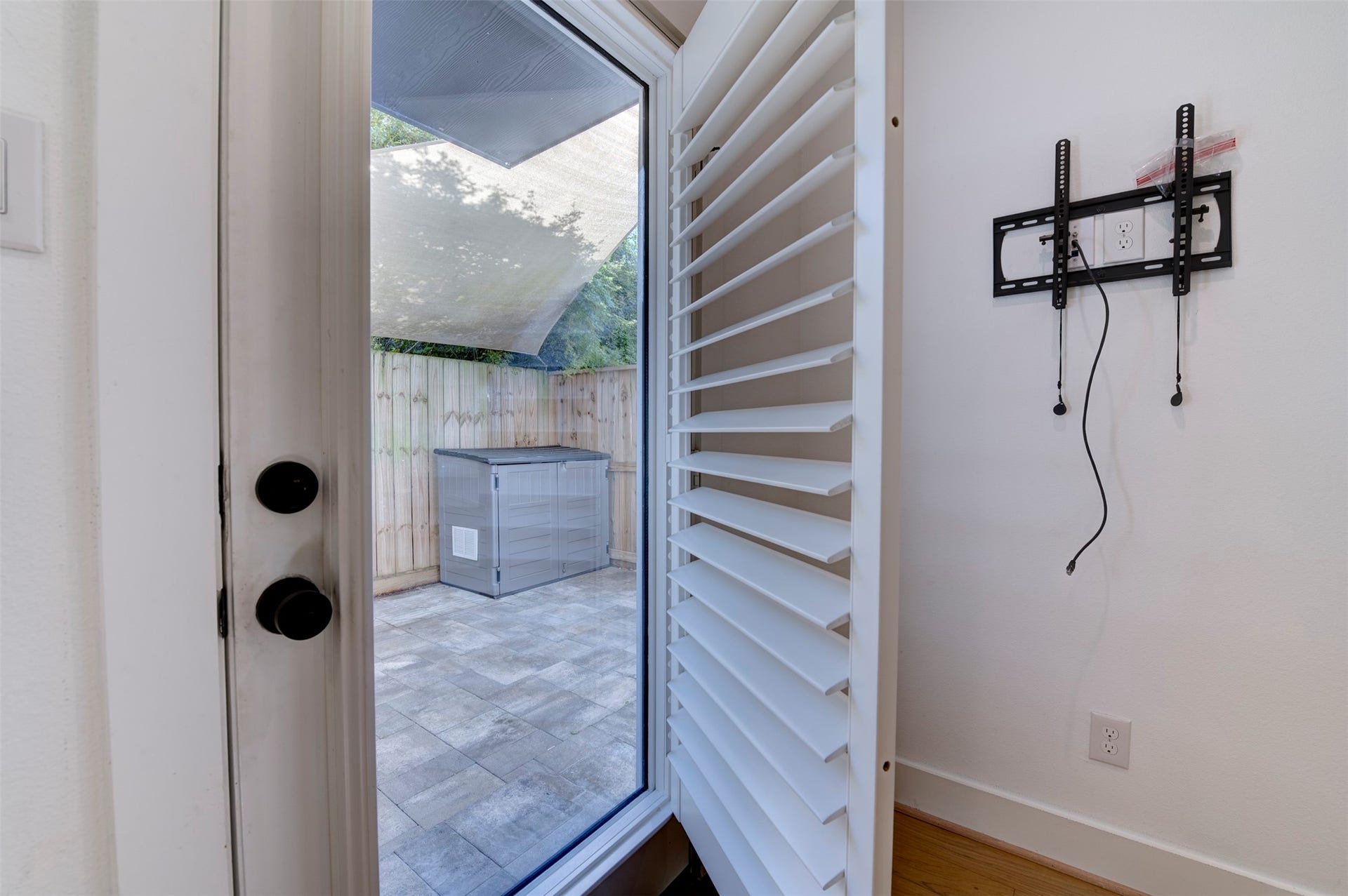 10910 Fire Creek Drive, Houston, TX 77043 Door leading to the patio with open and close shutters