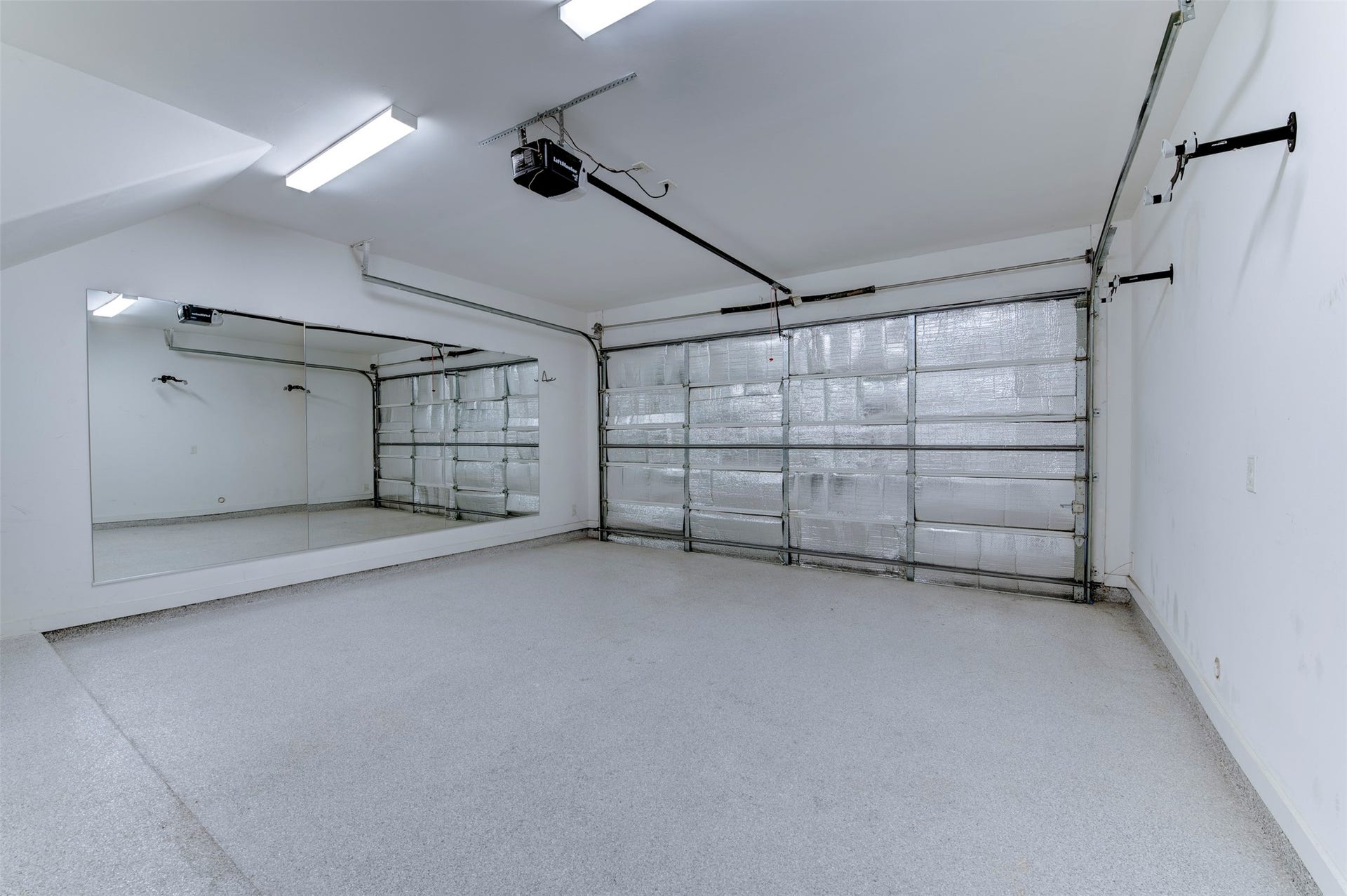10910 Fire Creek Drive, Houston, TX 77043 Two car garage with bike hooks and full wall mirror.
