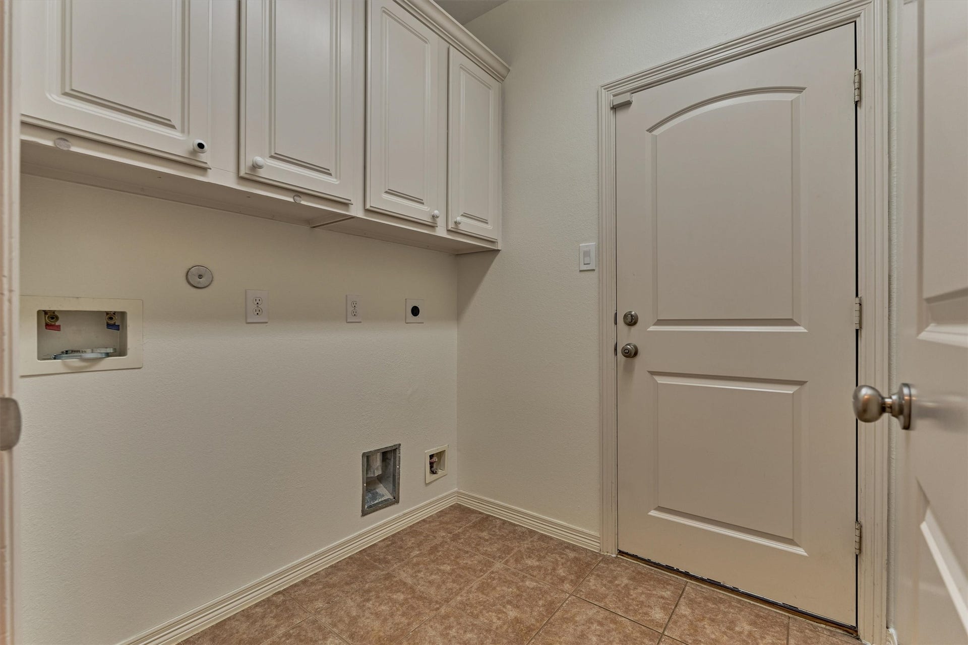 1794 Canyon Lake Creek Drive, Conroe, TX 77304 Laundry room off of the kitchen accesses the garage and has both electric and gas dryer hook ups along with cabinetry for storage.