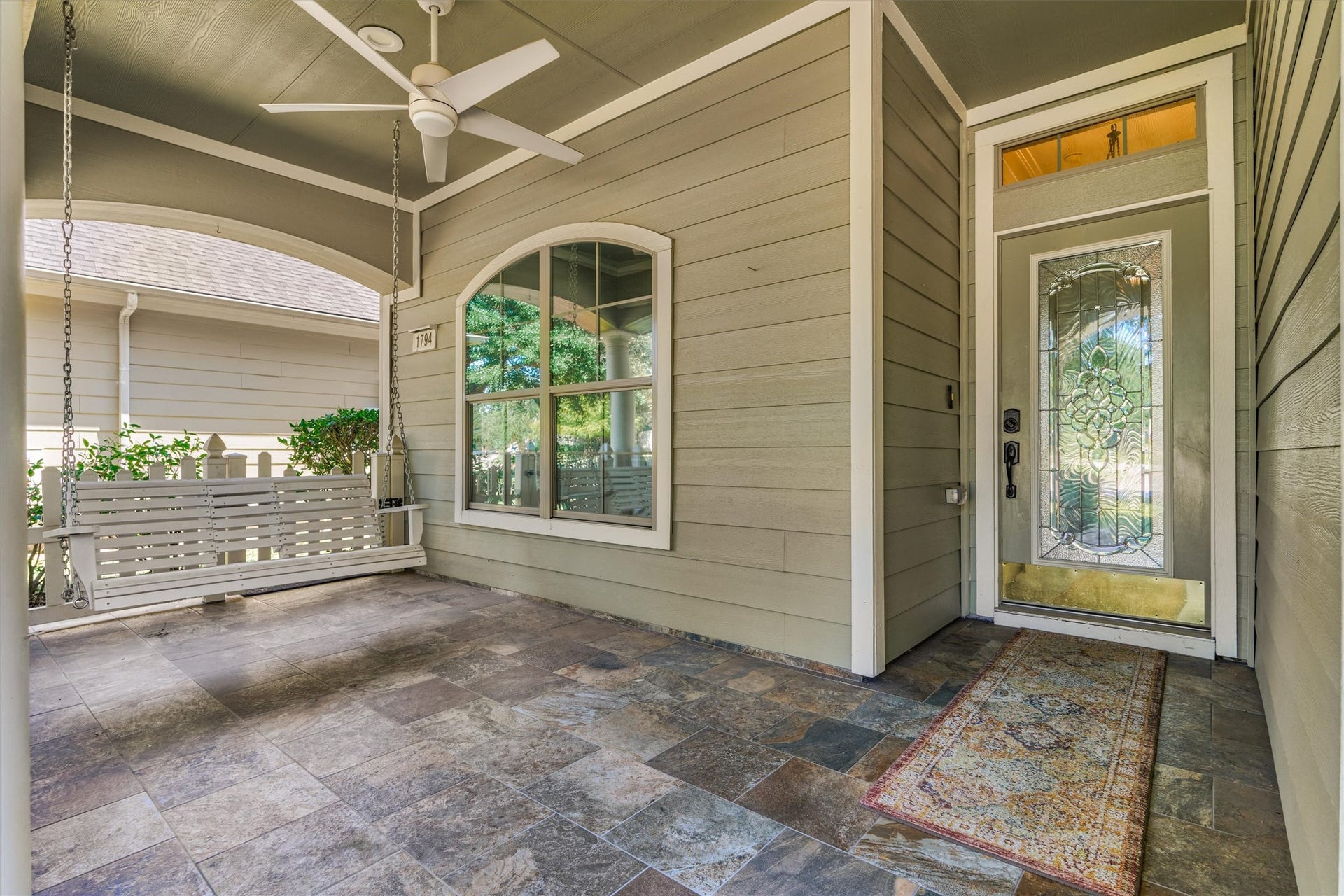 1794 Canyon Lake Creek Drive, Conroe, TX 77304 Large covered front porch with tile flooring and ceiling fan.