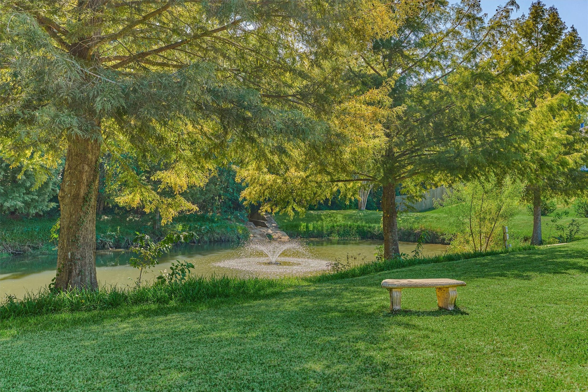1794 Canyon Lake Creek Drive, Conroe, TX 77304 Pond with fountain nearby and bench for a serene, peaceful setting.