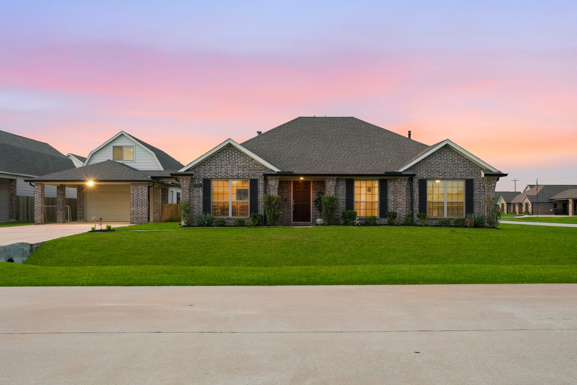 2102 Wikiup Street, Dickinson, TX 77539 Twilight view of front of home featuring updated landscaping.