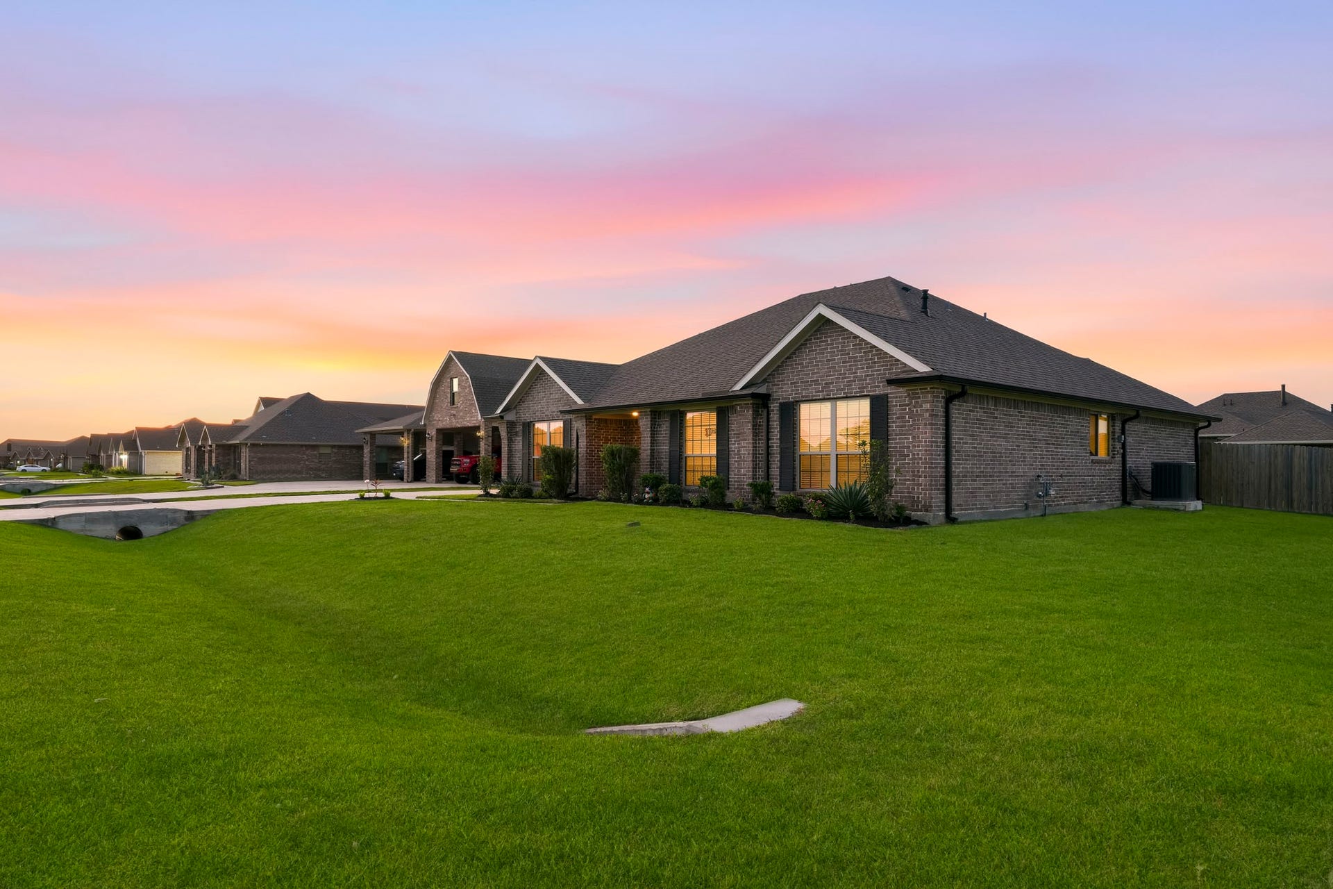 2102 Wikiup Street, Dickinson, TX 77539 Side view of home featuring lush grass.