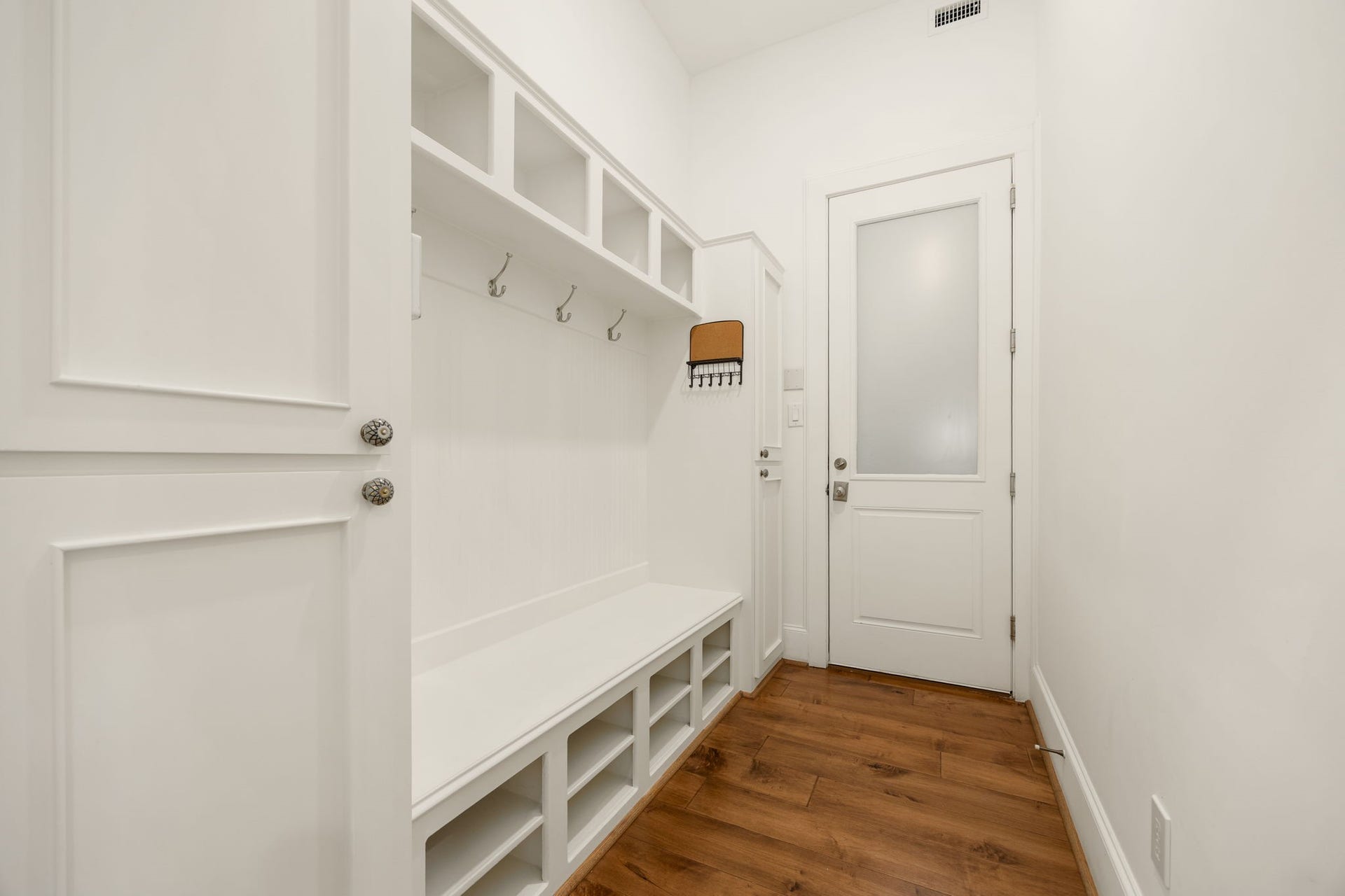 Keep everyday life organized with this thoughtfully designed mudroom, complete with a built in bench, open cubbies, overhead shelving, and convenient hooks for coats and bags. Its the perfect spot to settle in, kick off your shoes, and keep everything in its place!