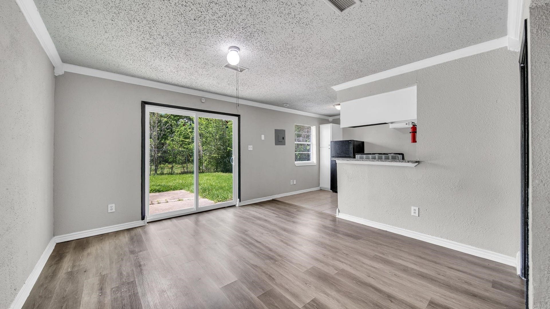 10902 Jutland Road, Houston, TX 77048 A sliding glass door invites natural light into the living space while providing seamless access to the backyard. With no rear neighbors, the outdoor setting offers an exceptional sense of privacy and a peaceful backdrop for relaxing and enjoying the outdoors.