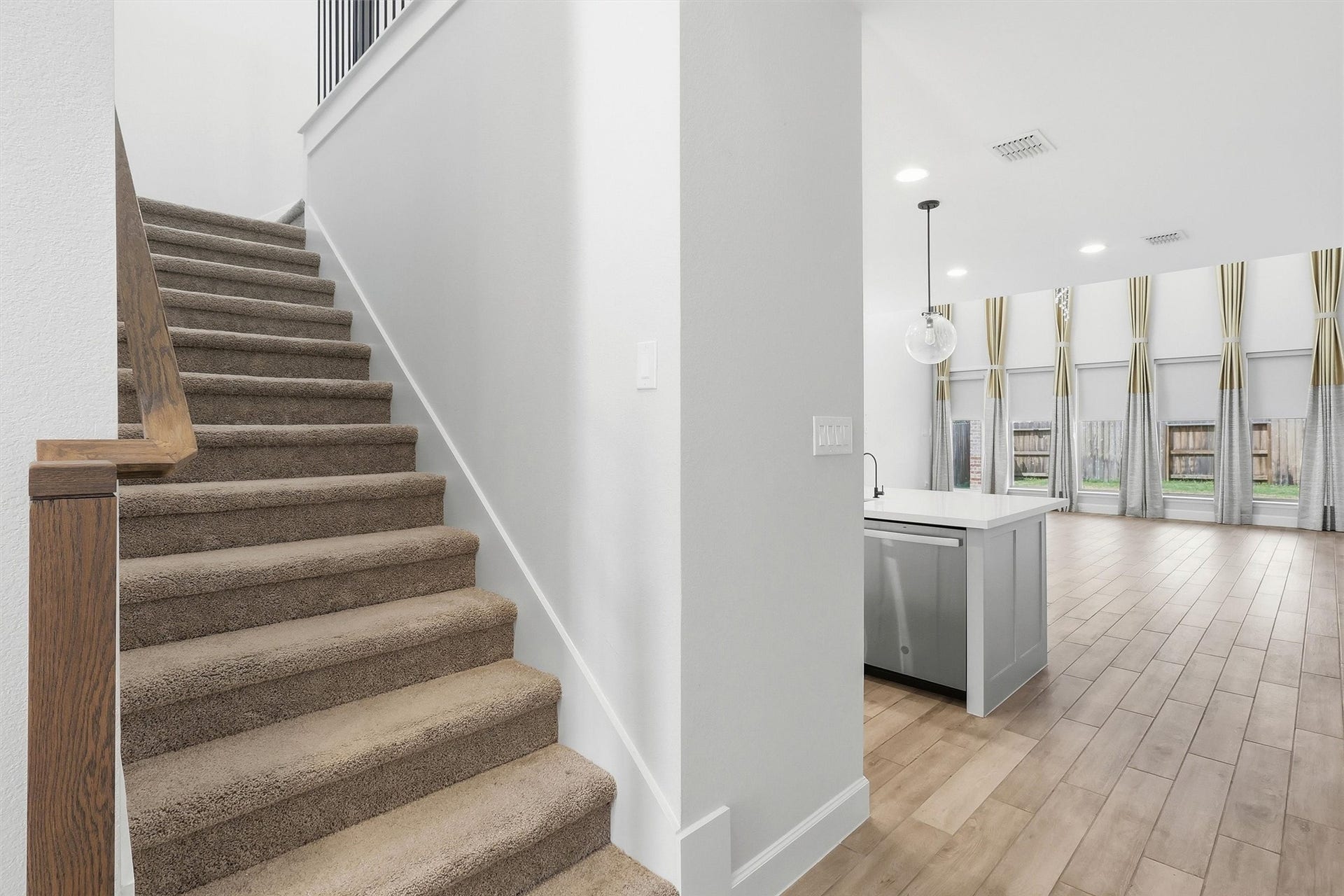 30135 Gold Finch Place, Fulshear, TX 77441 Ascend the plush carpeted staircase with rich wood railings and elegant wrought-iron spindles to discover the spacious second level, where additional living space and private bedrooms await.