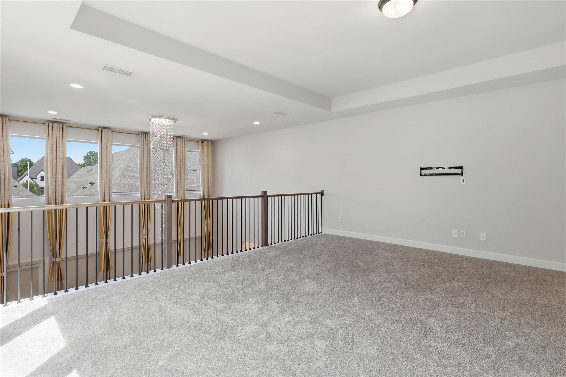 30135 Gold Finch Place, Fulshear, TX 77441 Another view showcases the generous proportions of this oversized game room. The open railing overlooks the impressive two-story foyer while walls of windows and elegant finishes make the space feel bright, open, and inviting.