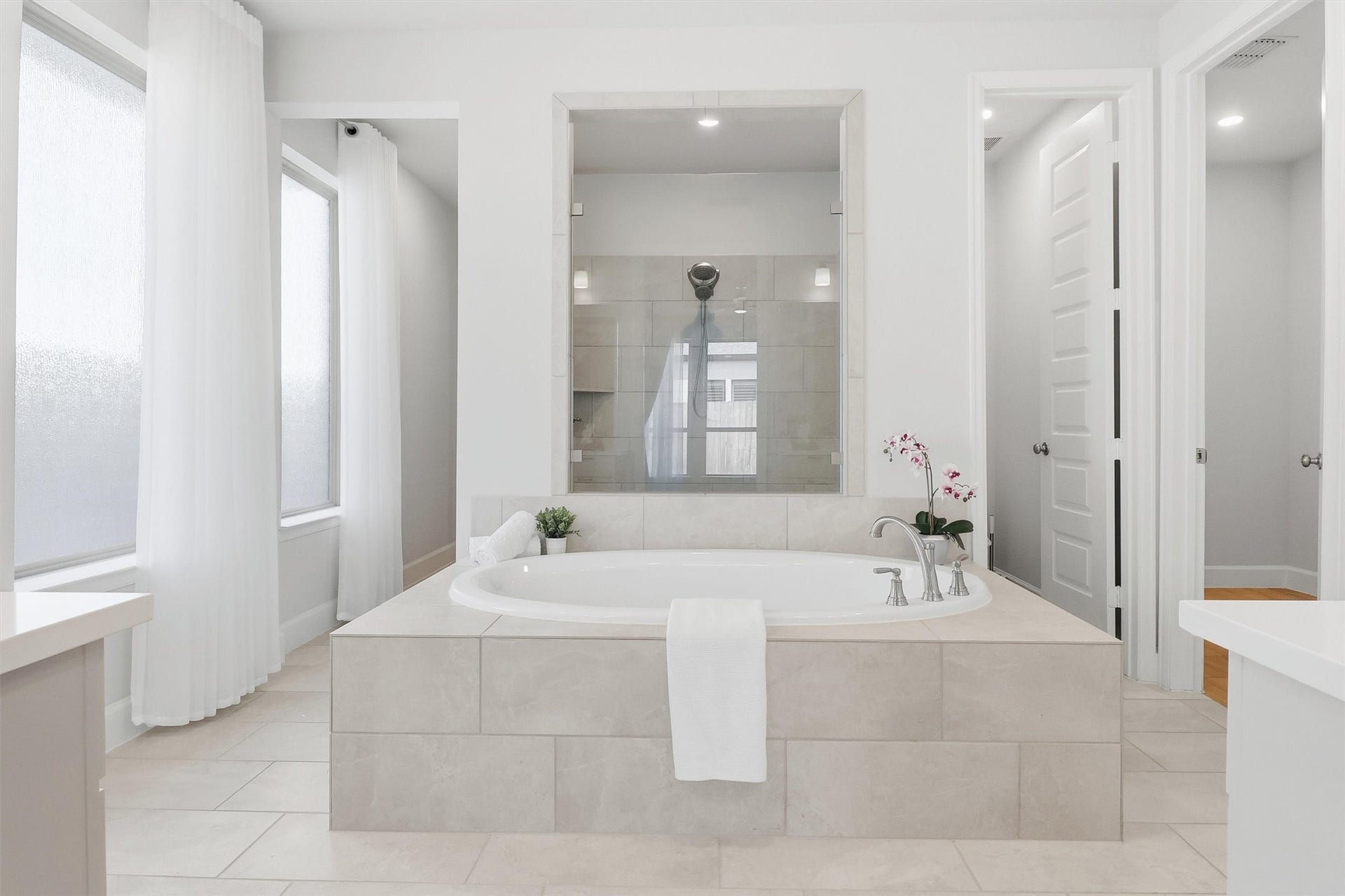 30135 Gold Finch Place, Fulshear, TX 77441 Designed with relaxation in mind, the spa-inspired primary bath centers around a luxurious soaking tub framed by elegant tilework. The open layout creates a tranquil atmosphere while providing easy access to the oversized walk-in shower and dual vanities.