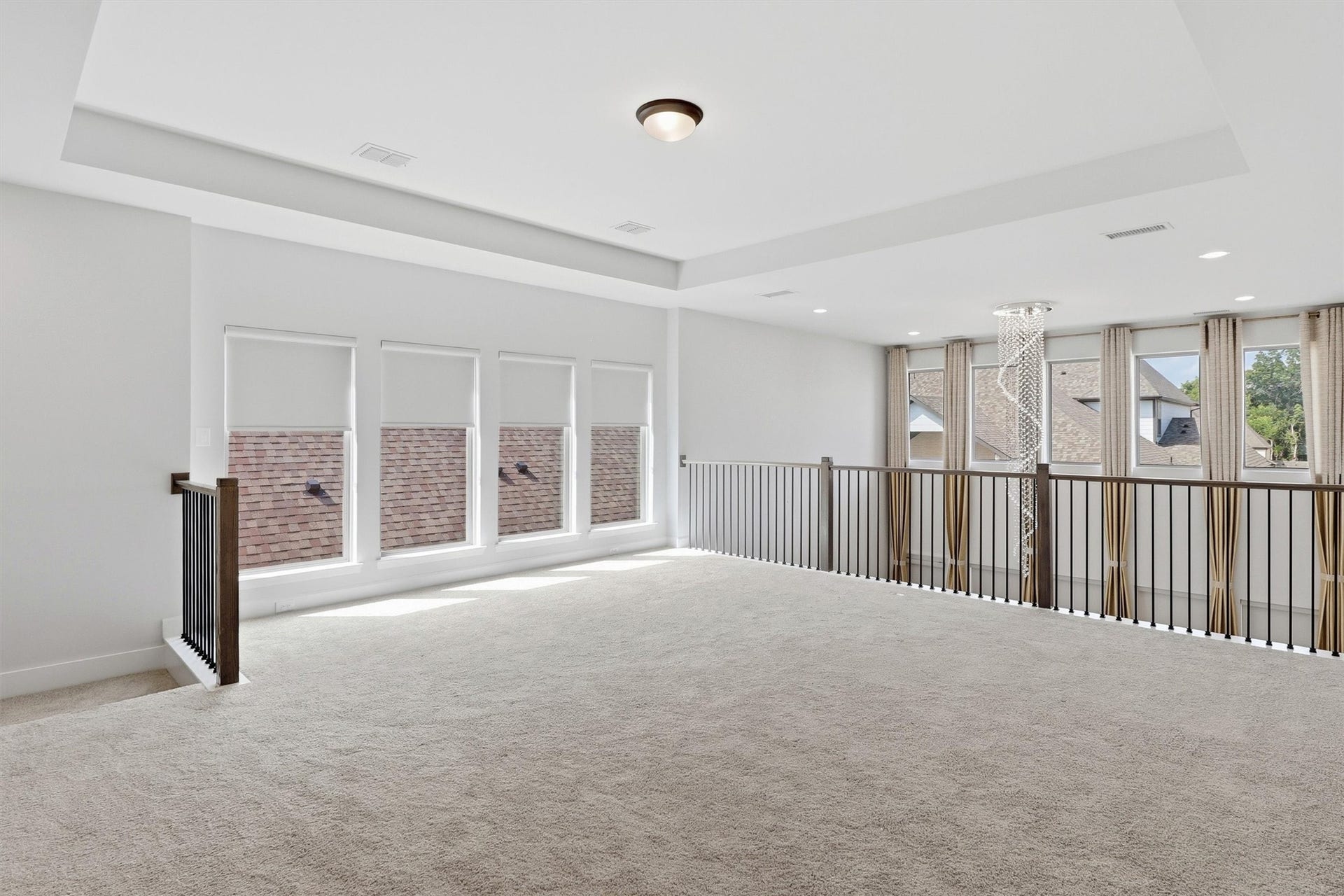 30135 Gold Finch Place, Fulshear, TX 77441 The expansive upstairs game room offers endless flexibility for a media lounge, playroom, home gym, or additional living space. A tray ceiling, plush carpeting, and abundant natural light create a bright and welcoming atmosphere.