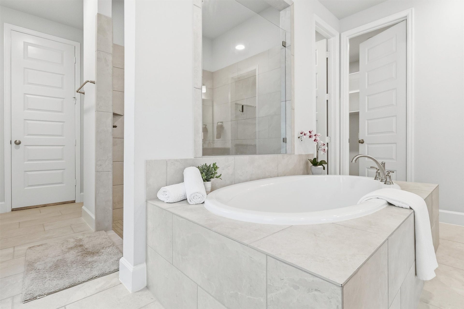 30135 Gold Finch Place, Fulshear, TX 77441 Every detail of the primary bath has been thoughtfully designed, from the oversized soaking tub and spacious shower to the seamless flow into the expansive walk-in closet, creating a true owner's retreat.