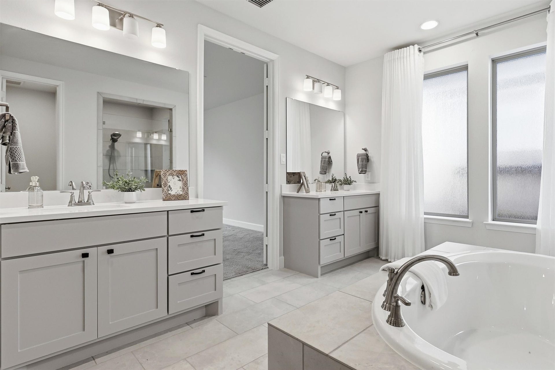 30135 Gold Finch Place, Fulshear, TX 77441 Separate vanities offer abundant storage, generous countertop space, and individual prep areas, making busy mornings effortless. Soft natural light, designer fixtures, and timeless finishes complete this elegant retreat.