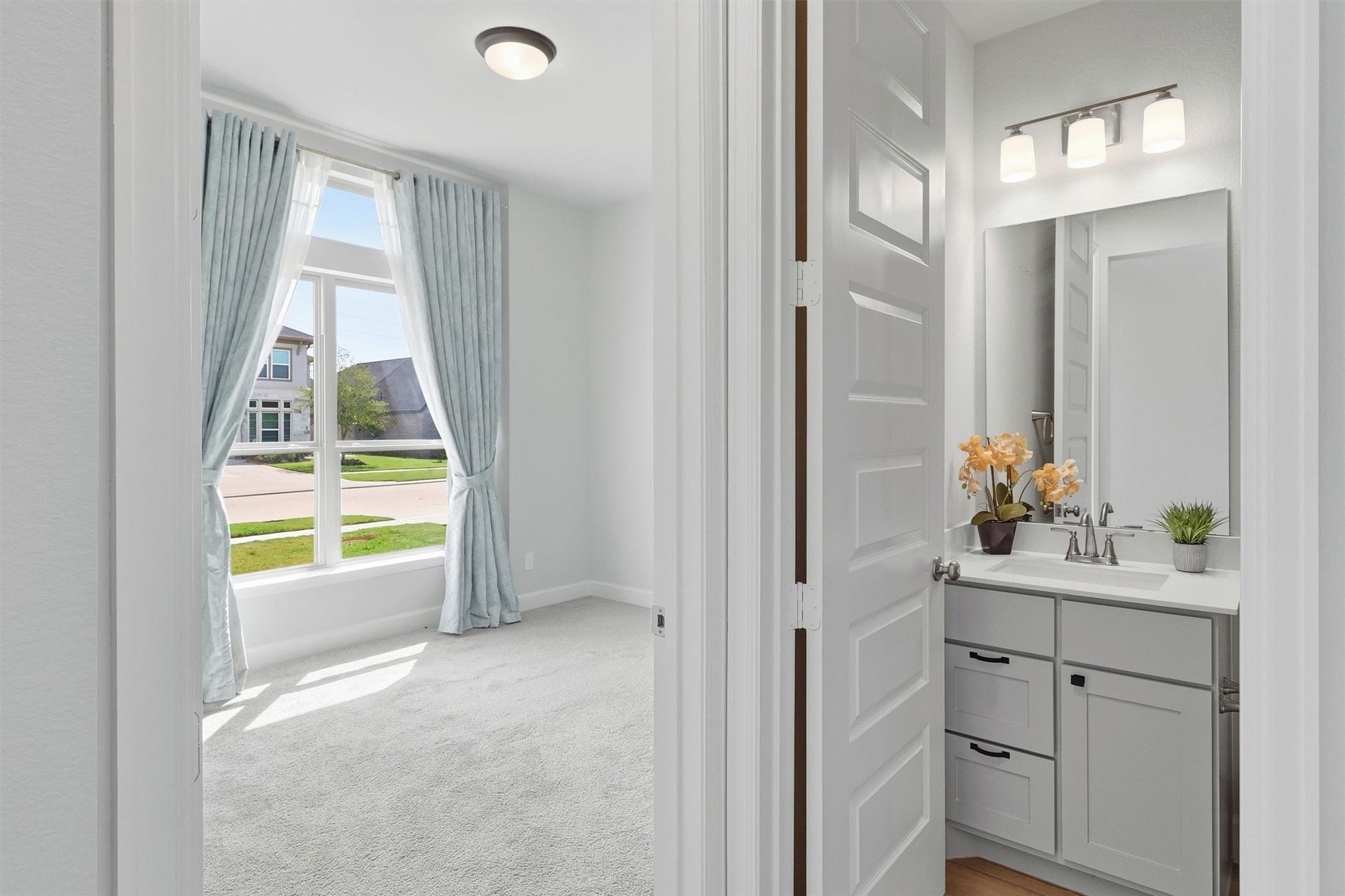 30135 Gold Finch Place, Fulshear, TX 77441 This generously sized secondary bedroom is filled with natural light from a large front-facing window accented by custom drapery. Plush carpeting and a neutral color palette create a bright, inviting space that's ready to personalize.