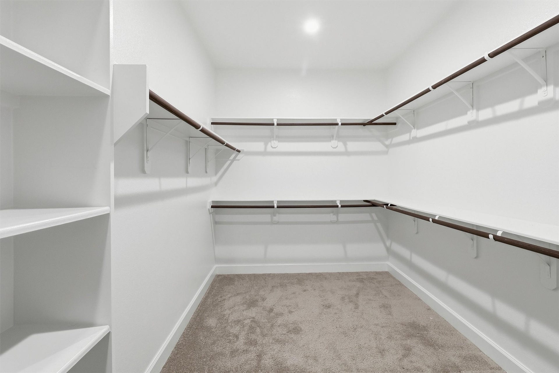 30135 Gold Finch Place, Fulshear, TX 77441 The impressive walk-in closet offers exceptional storage with wraparound hanging space, built-in shelving, and room to easily organize clothing, shoes, and accessories while keeping everything within reach. There is still a second closet in the primary bathroom.