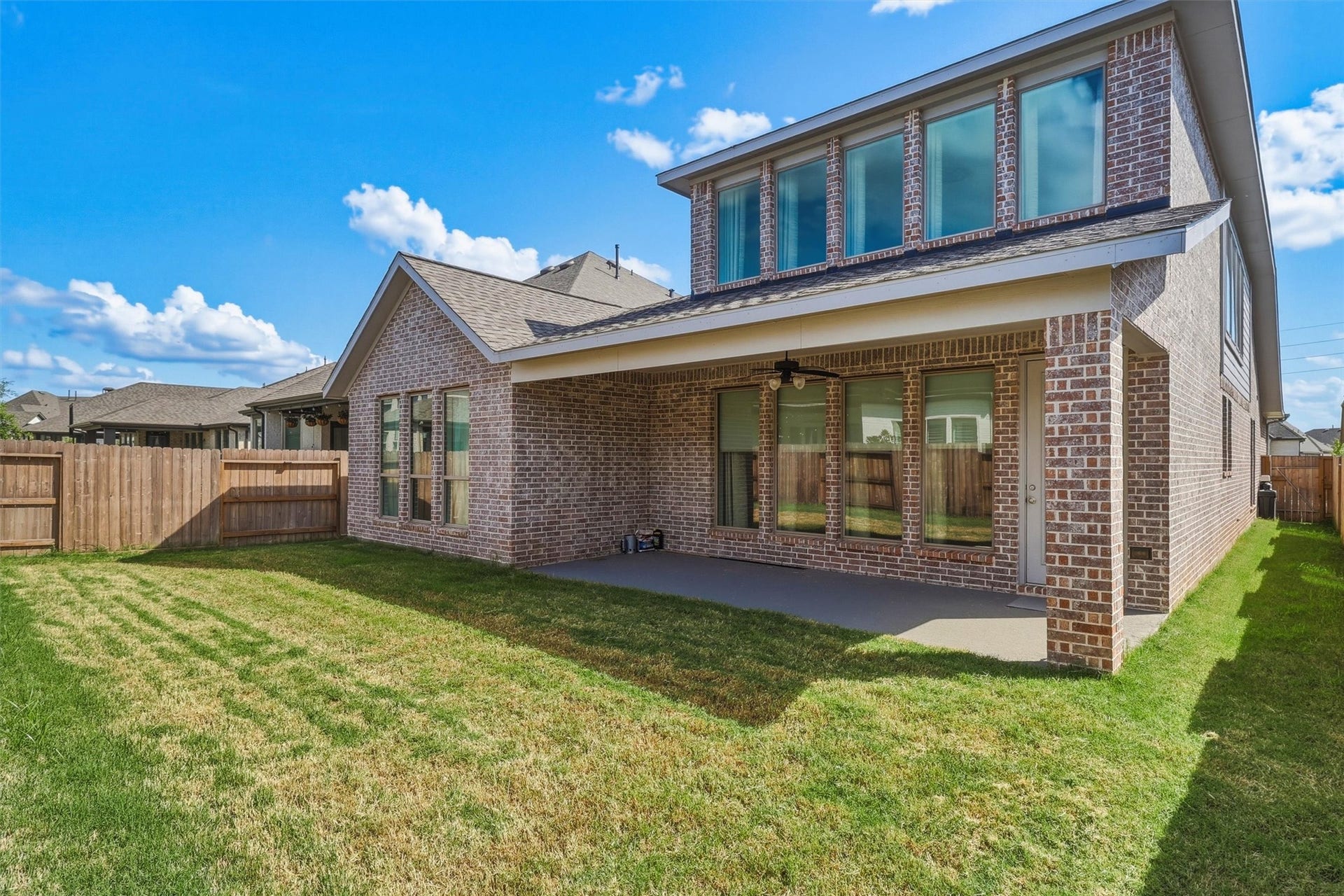 30135 Gold Finch Place, Fulshear, TX 77441 The backyard offers the perfect balance of open green space and covered outdoor living. Whether entertaining guests, letting pets roam, or simply enjoying a quiet evening outdoors, this space is ready to fit your lifestyle.