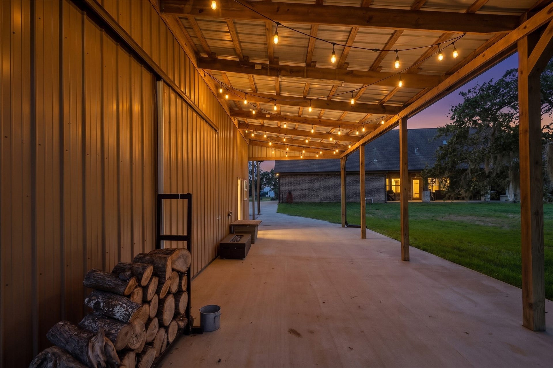 Covered gathering space off the barn looking into backyard