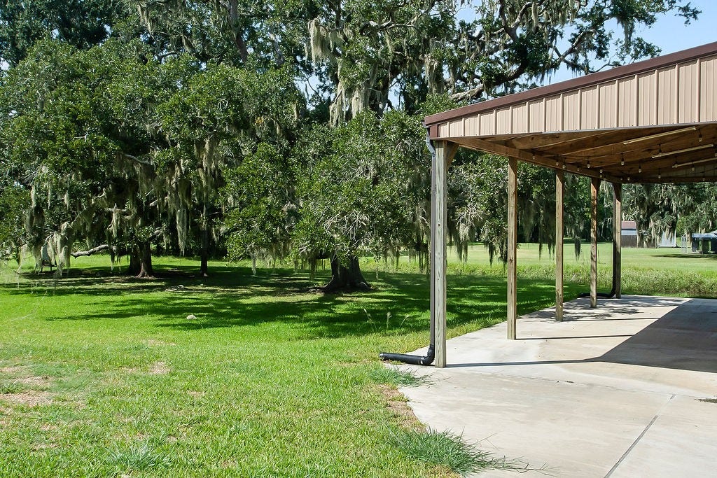 View of barn and back yard space from the driveway at back of house