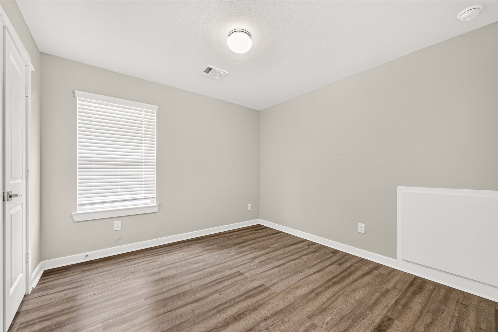 32922 Ruthie Dean Drive, Fulshear, TX 77423 An upstairs secondary bedroom offers natural light, closet storage, and carpet-free flooring.
