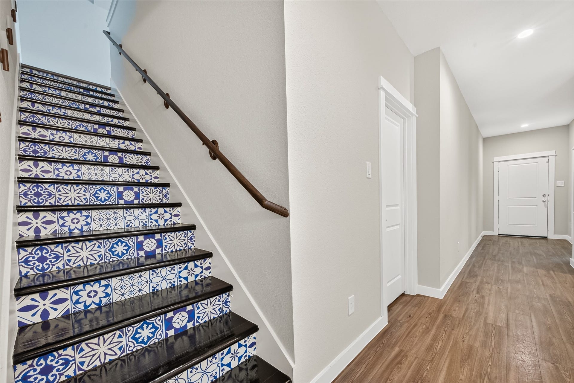 32922 Ruthie Dean Drive, Fulshear, TX 77423 Decorative patterned stair risers add a distinctive touch along the staircase leading to the upstairs living spaces.