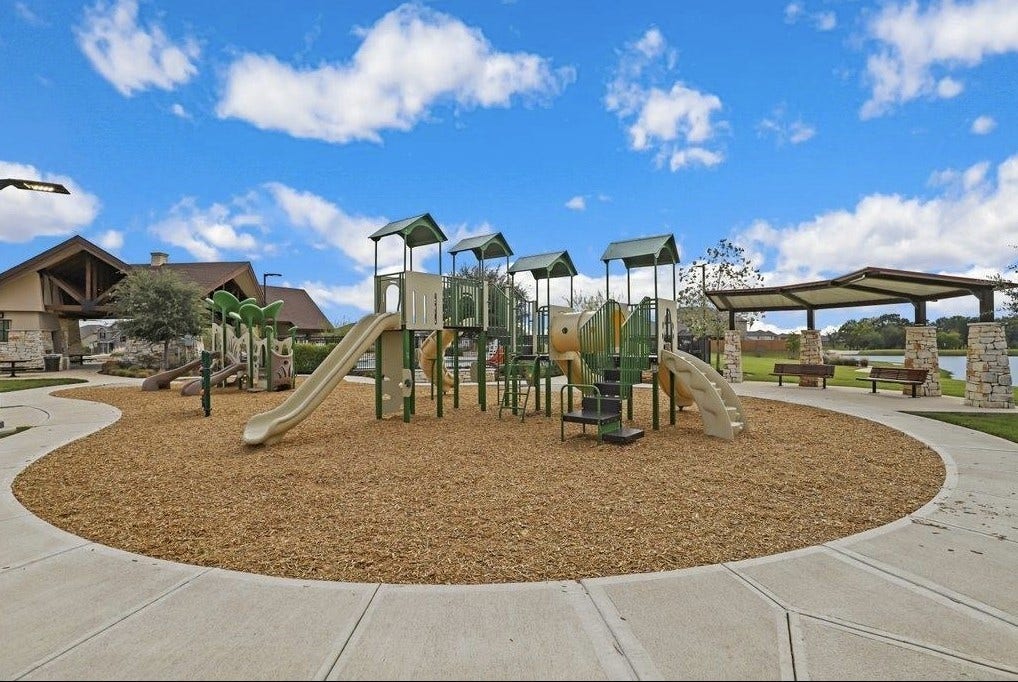 32922 Ruthie Dean Drive, Fulshear, TX 77423 Vanbrookes community playground offers slides, climbing features, and nearby covered seating. Community amenitynot located on the subject property.