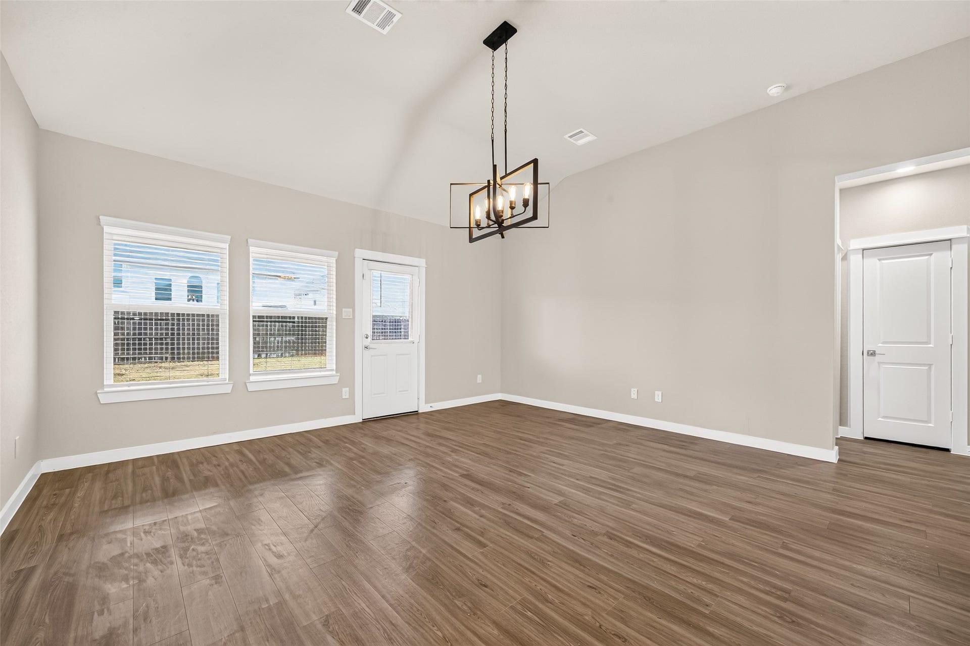 32922 Ruthie Dean Drive, Fulshear, TX 77423 Backyard-facing windows bring natural light into the family room, with a nearby door leading to the covered patio.