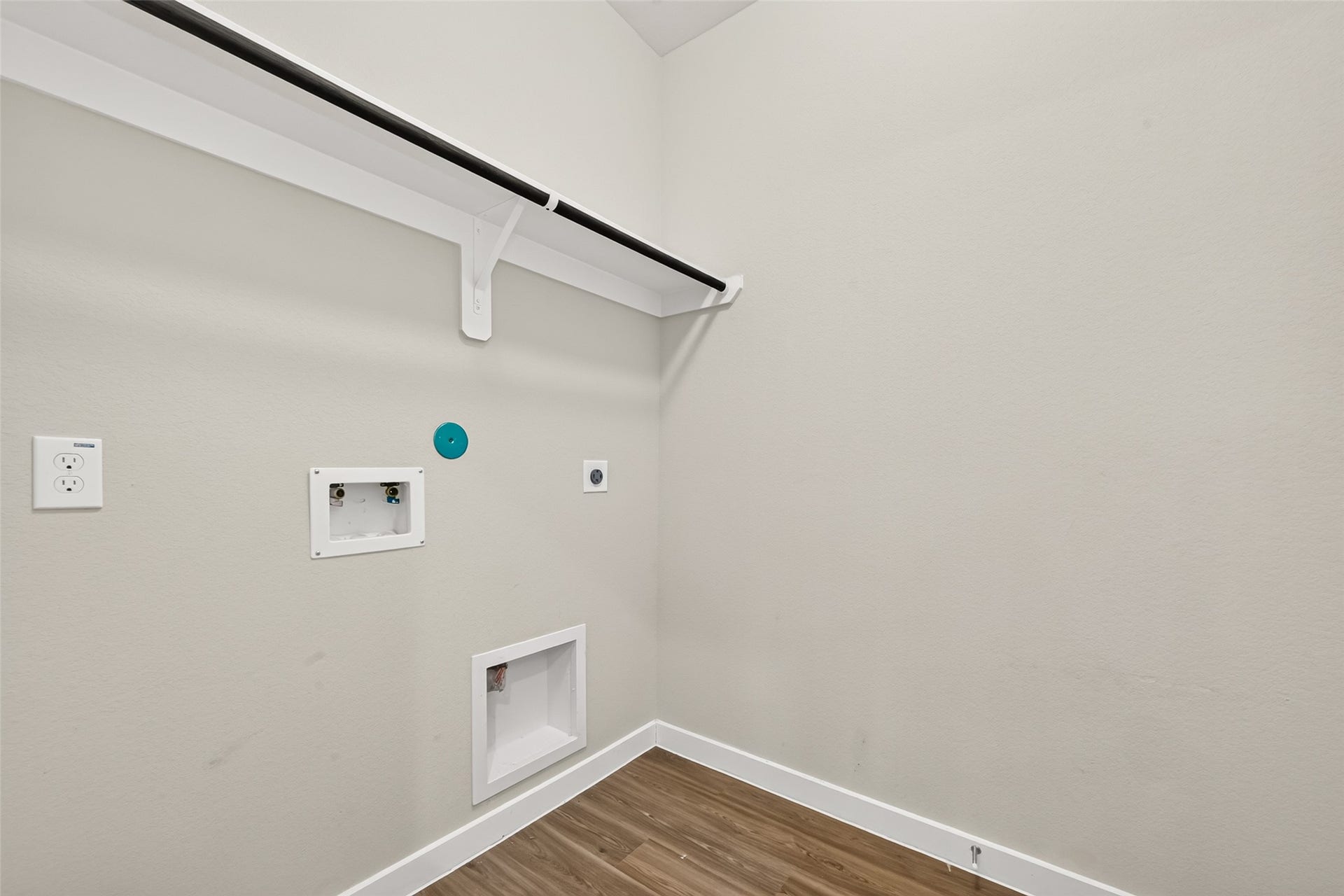 32922 Ruthie Dean Drive, Fulshear, TX 77423 The utility room includes washer and dryer connections, an overhead shelf, and a hanging rod.