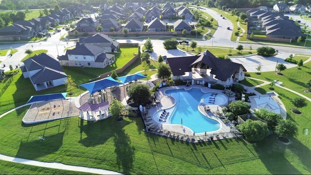 32922 Ruthie Dean Drive, Fulshear, TX 77423 An aerial view of Vanbrookes community recreation area, including the pool, splash pad, and playground. Community amenitiesnot located on the subject property.