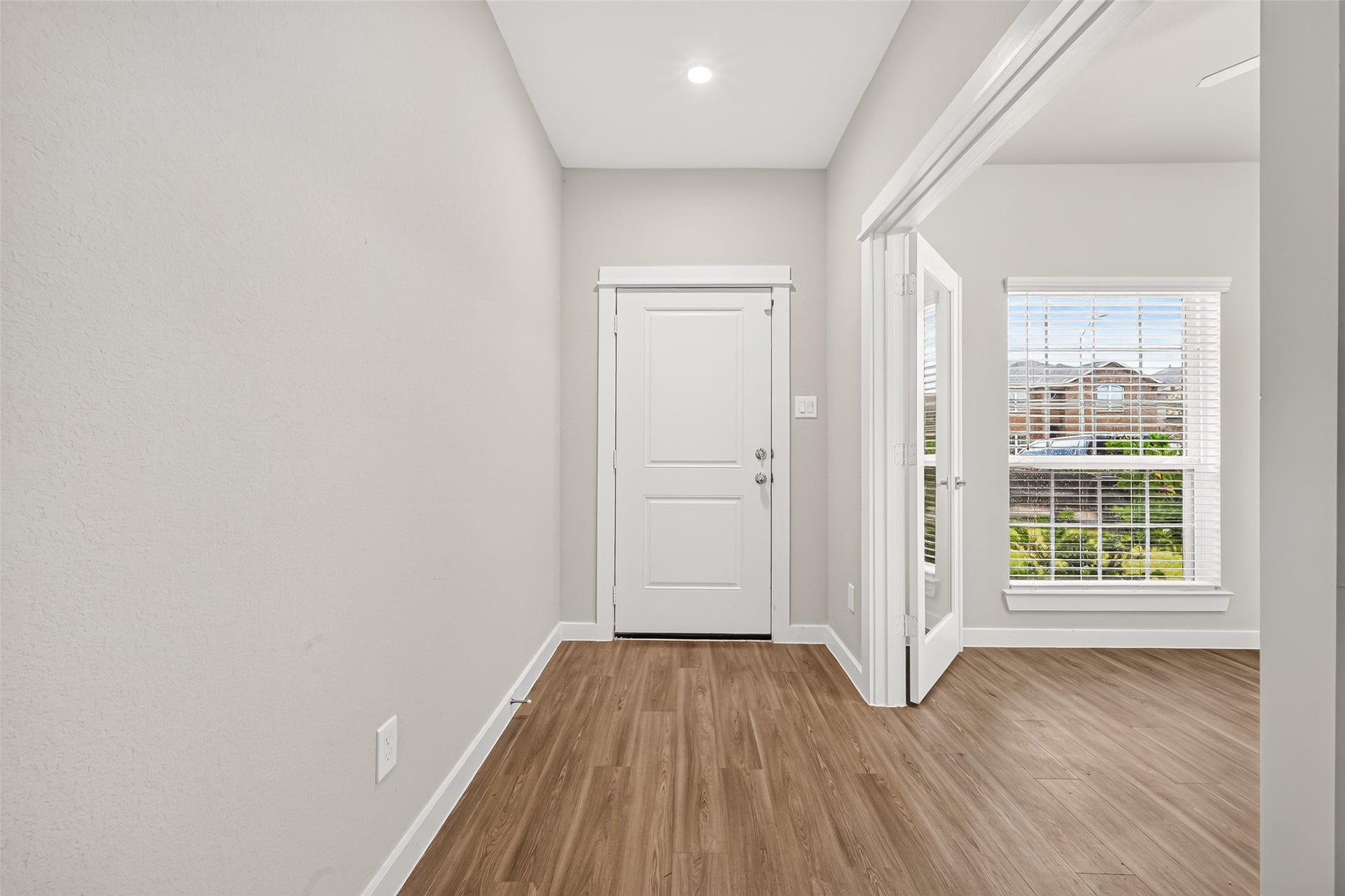 32922 Ruthie Dean Drive, Fulshear, TX 77423 The entry hallway welcomes you with neutral finishes, wood-look flooring, and convenient access to the study.