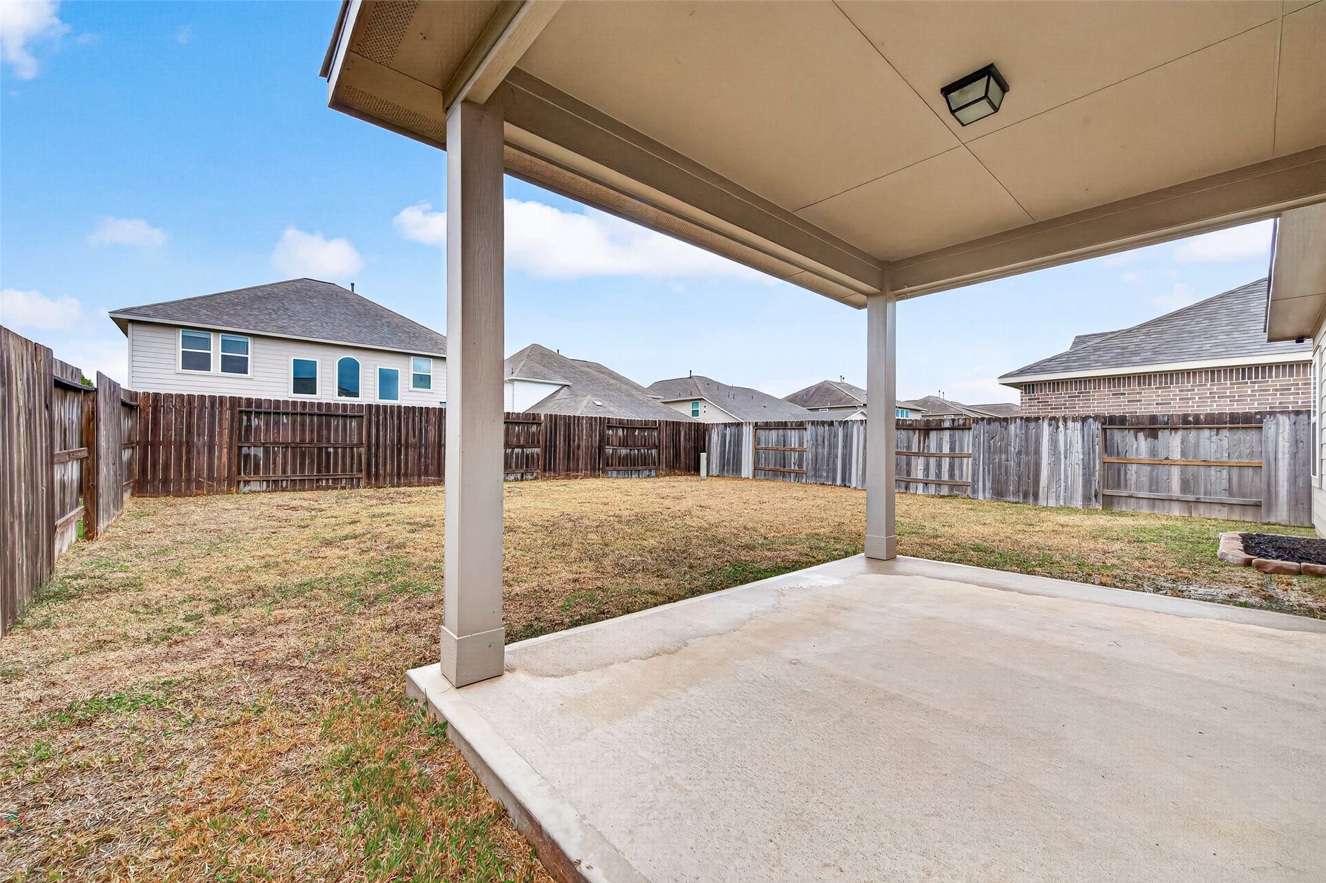 32922 Ruthie Dean Drive, Fulshear, TX 77423 A brick archway and sheltered front entry create a welcoming approach to the home.