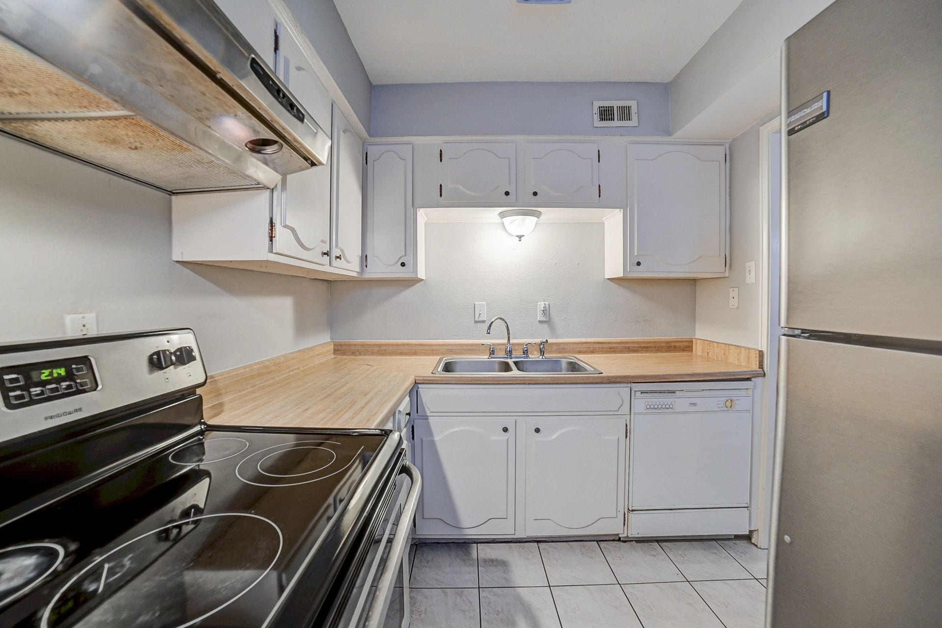 7900 Westheimer Road, #202, Houston, TX 77063 Charming kitchen with modern stainless steel appliances, ample cabinetry, and a cozy layout perfect for culinary creativity.