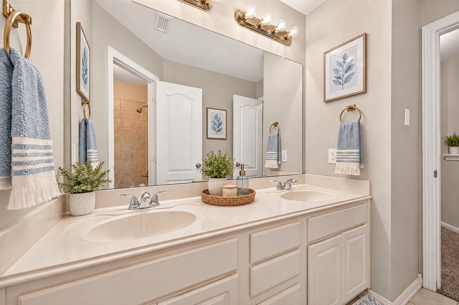 21834 Canton Pass Lane, Katy, TX 77450 The upstairs secondary full bathroom features double sinks, generous cabinet storage, and a large mirror that helps keep the space feeling bright and open. A practical setup with plenty of room for shared daily routines. **Virtually Staged**
