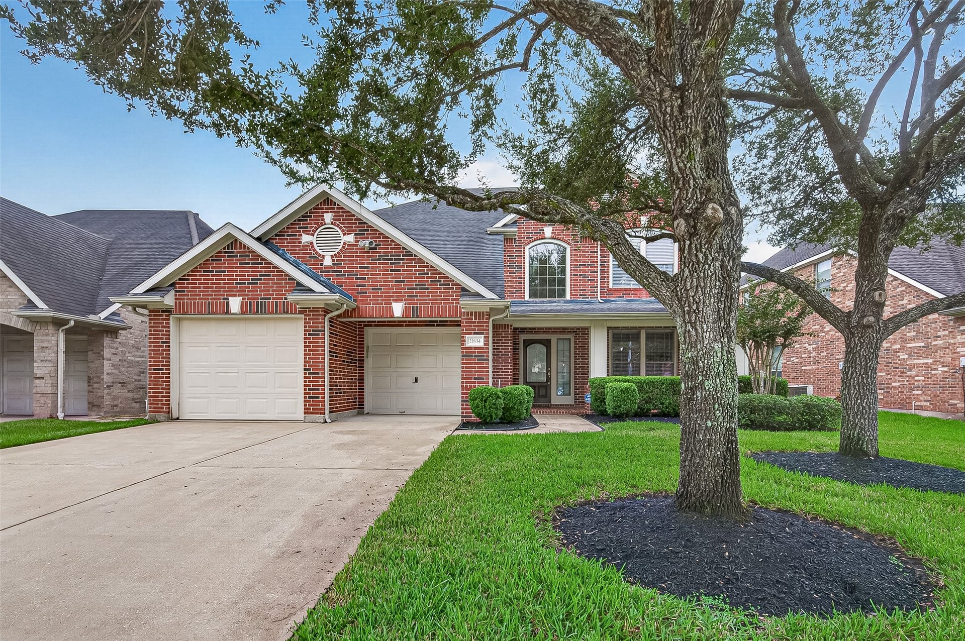 21834 Canton Pass Lane, Katy, TX 77450 This home features a classic brick exterior with a spacious double-wide driveway leading to a 3-car tandem garage, offering plenty of room for vehicles and storage. The inviting entry and well-designed front elevation create a polished, welcoming first impression.