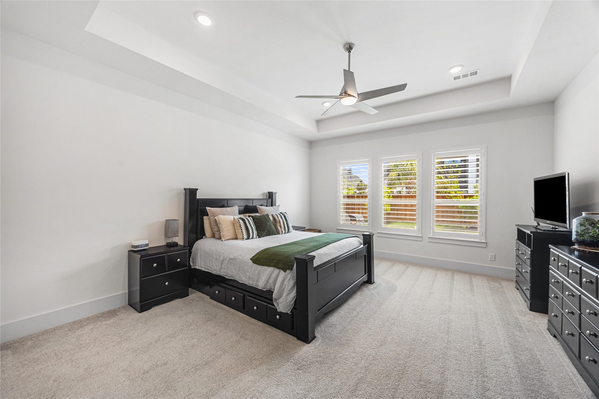 4114 Pleasant Ridge Drive, Spring, TX 77386 Oversized primary bedroom filled with natural light from large windows, offering a spacious and serene retreat.