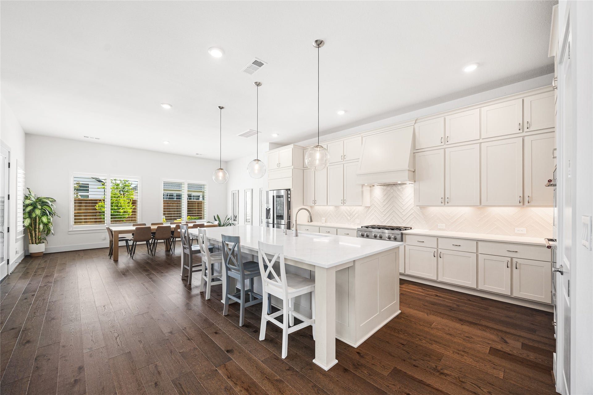 4114 Pleasant Ridge Drive, Spring, TX 77386 Kitchen-dining area centered around an oversized island, creating the perfect hub for gathering, casual dining, and entertaining.