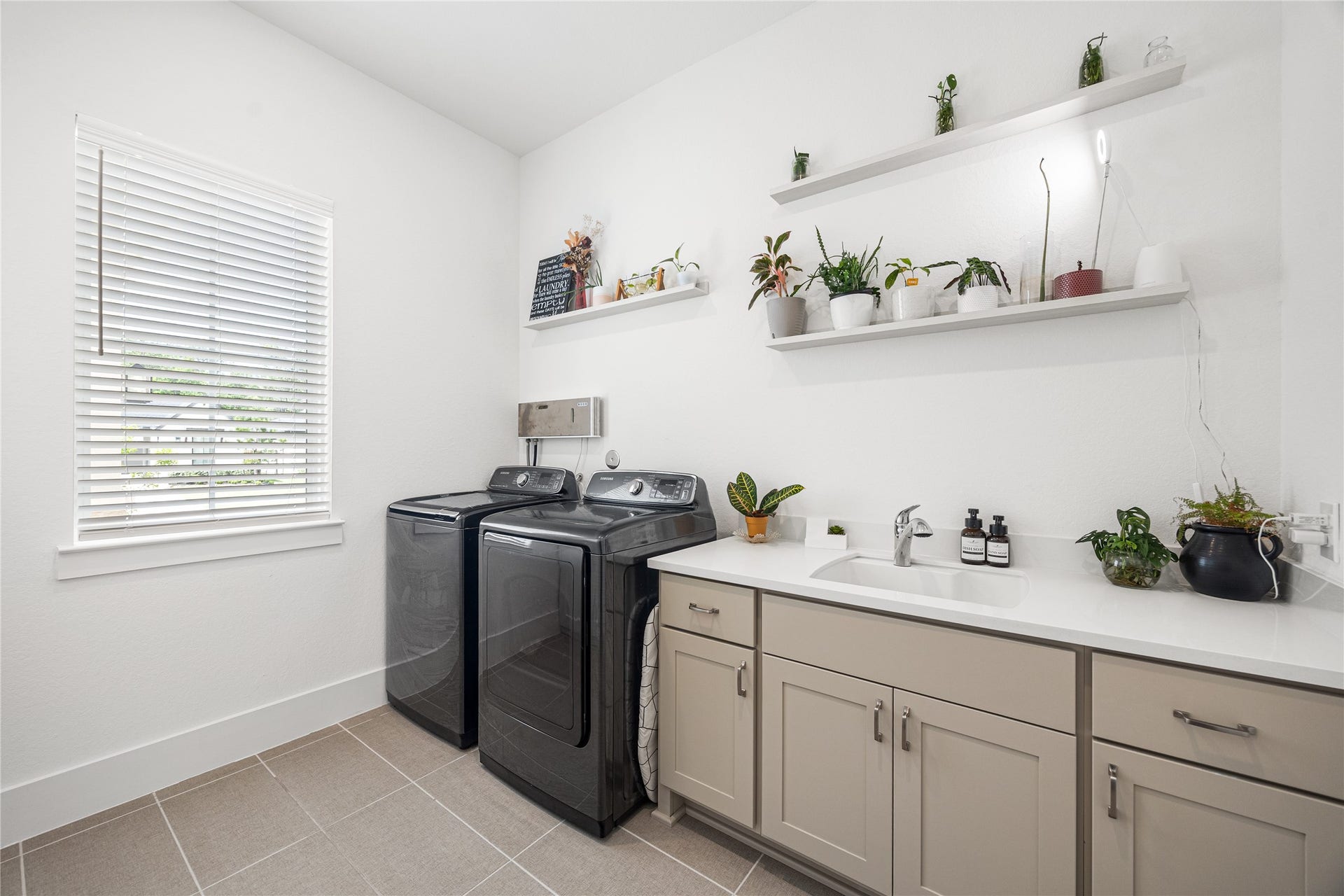 4114 Pleasant Ridge Drive, Spring, TX 77386 Laundry room with sink and cabinets.