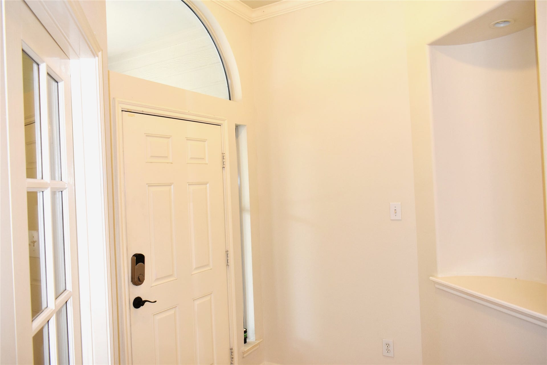 4822 Harbor Glen Lane, Houston, TX 77084 Bright and welcoming entryway with a stylish arched window and modern door hardware, offering a warm first impression.