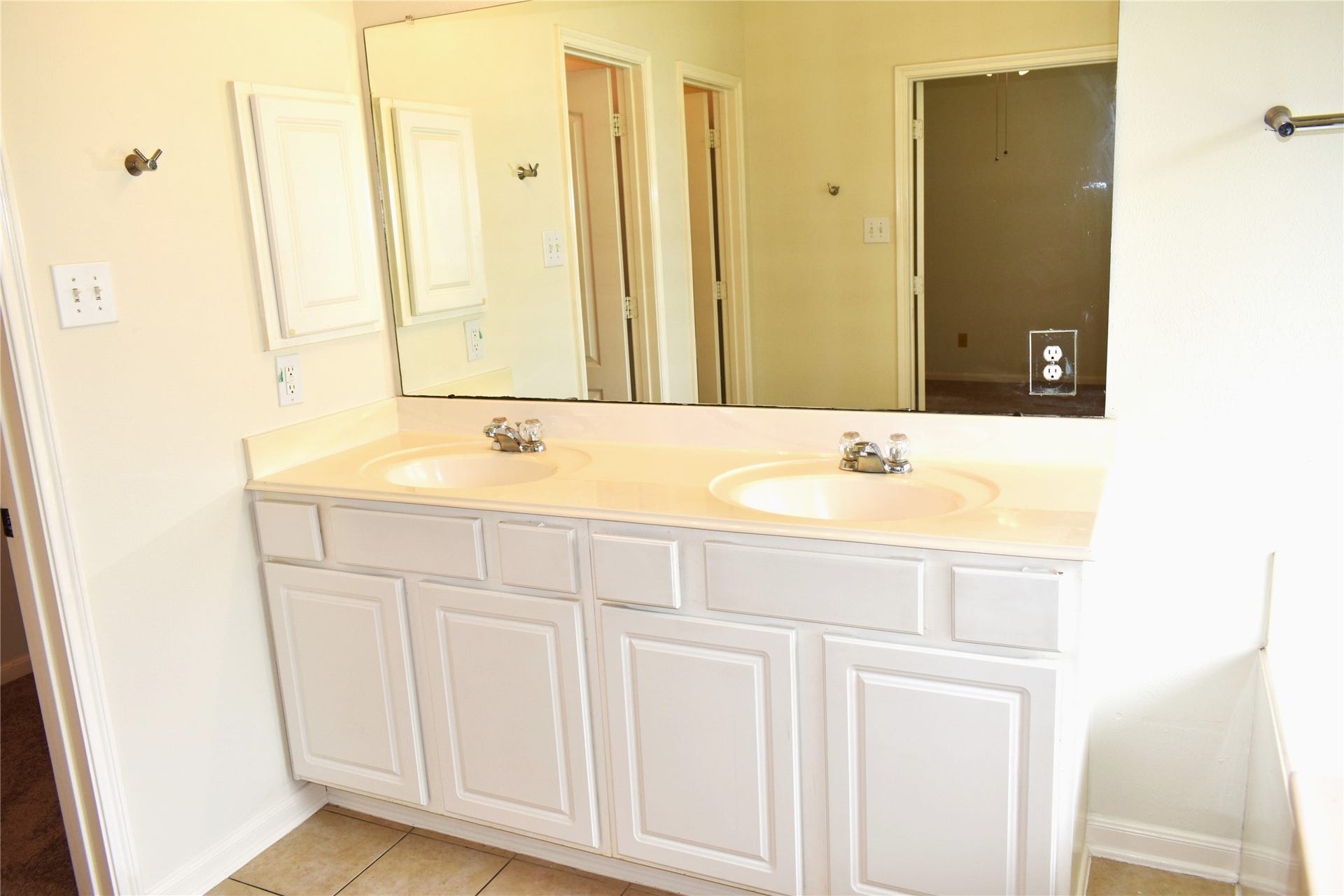 4822 Harbor Glen Lane, Houston, TX 77084 Bright bathroom with dual sinks, a large mirror, and ample cabinet storage.