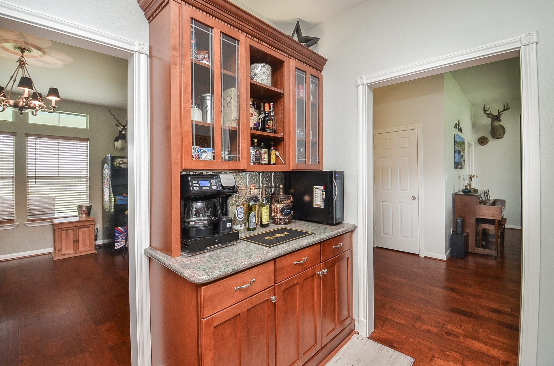 27644 Spring Hill Road, Hempstead, TX 77445 Elegant glass-front cabinets offer stylish storage and display space, enhancing the kitchen's charm.