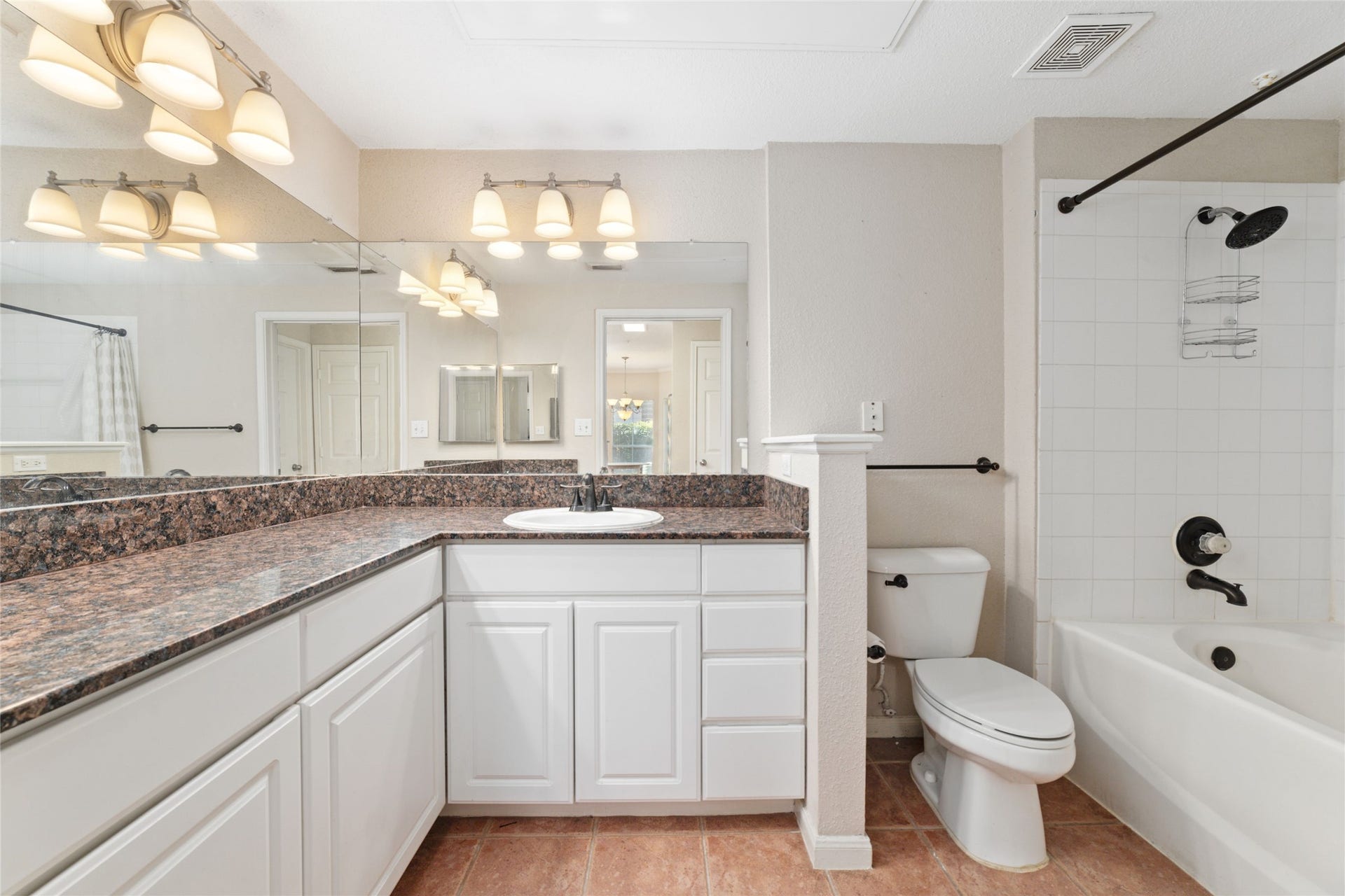 Sleek and stylish bathroom with modern fixtures, ample counter space, and a relaxing tub/shower combo.